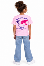 Youth model wearing the light pink short sleeve t-shirt, back view